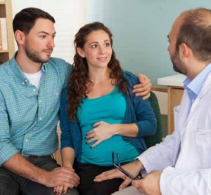 Pregnant couple with doctor